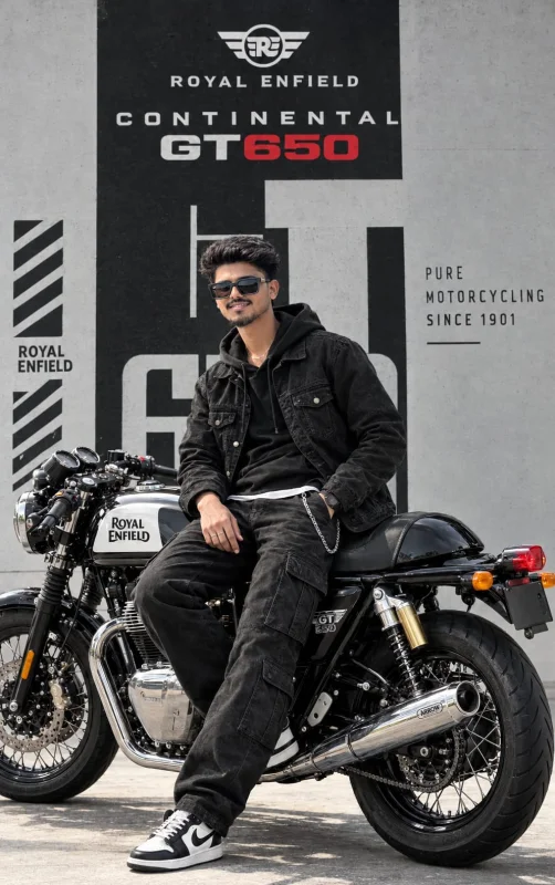 A young man in an all-black outfit sitting on a Royal Enfield Continental GT 650 motorcycle in a cinematic black-and-white studio setting.